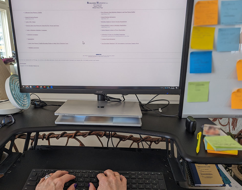 berkshire hathaway website on screen of computer on a desk