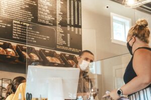 A woman gets her pickup order from a deli during the COVID pandemic.